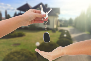 house keys in front of a new home