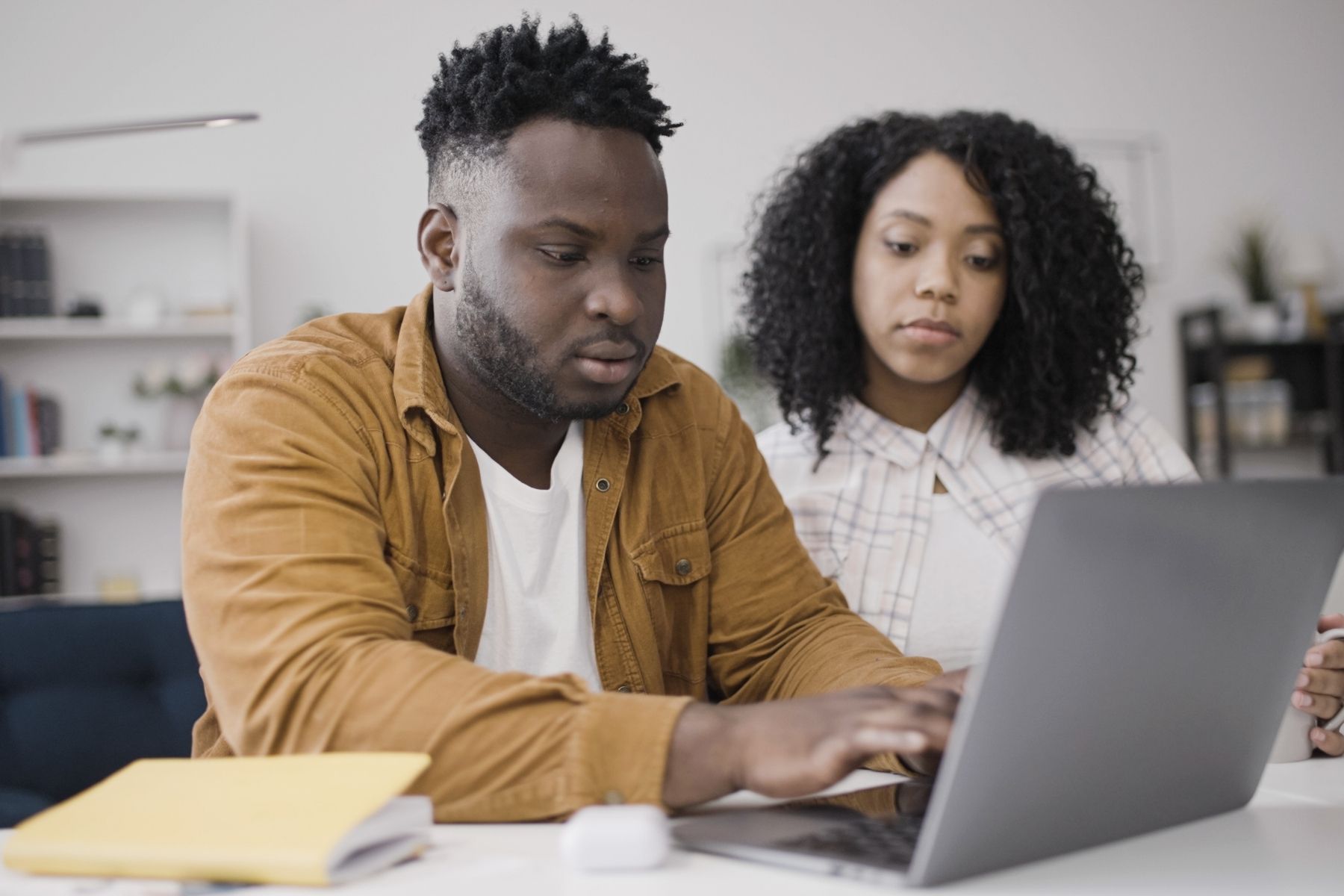 Young couple looking at their laptop applying for their mortgage