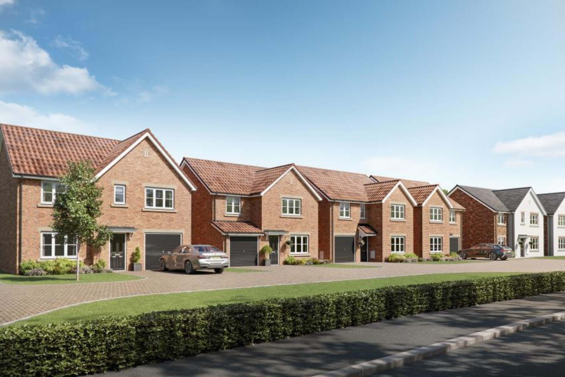 Street scene of large detached new homes with garages at Forest View in Nottingham.