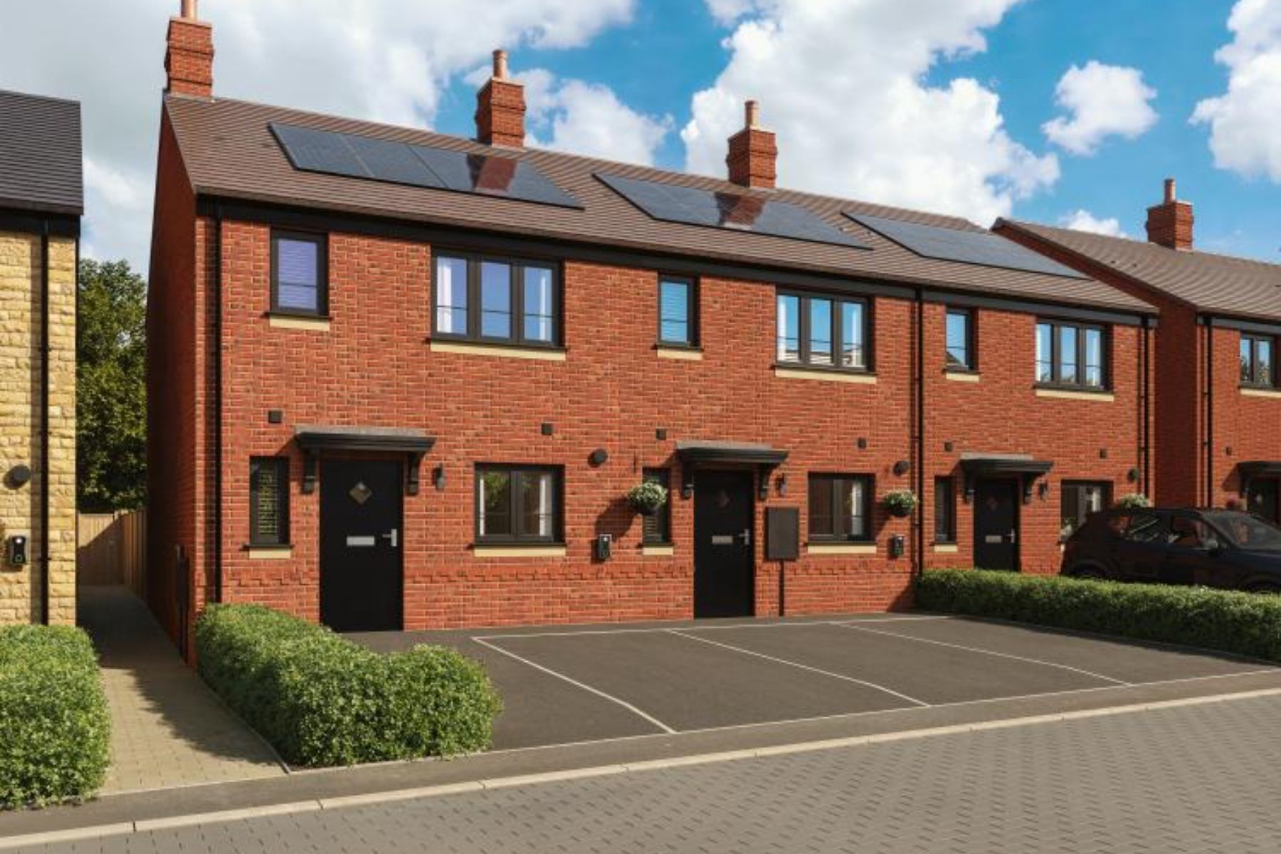 Detached red brick home with dark window frames at Willowbank Meadows in Alderton