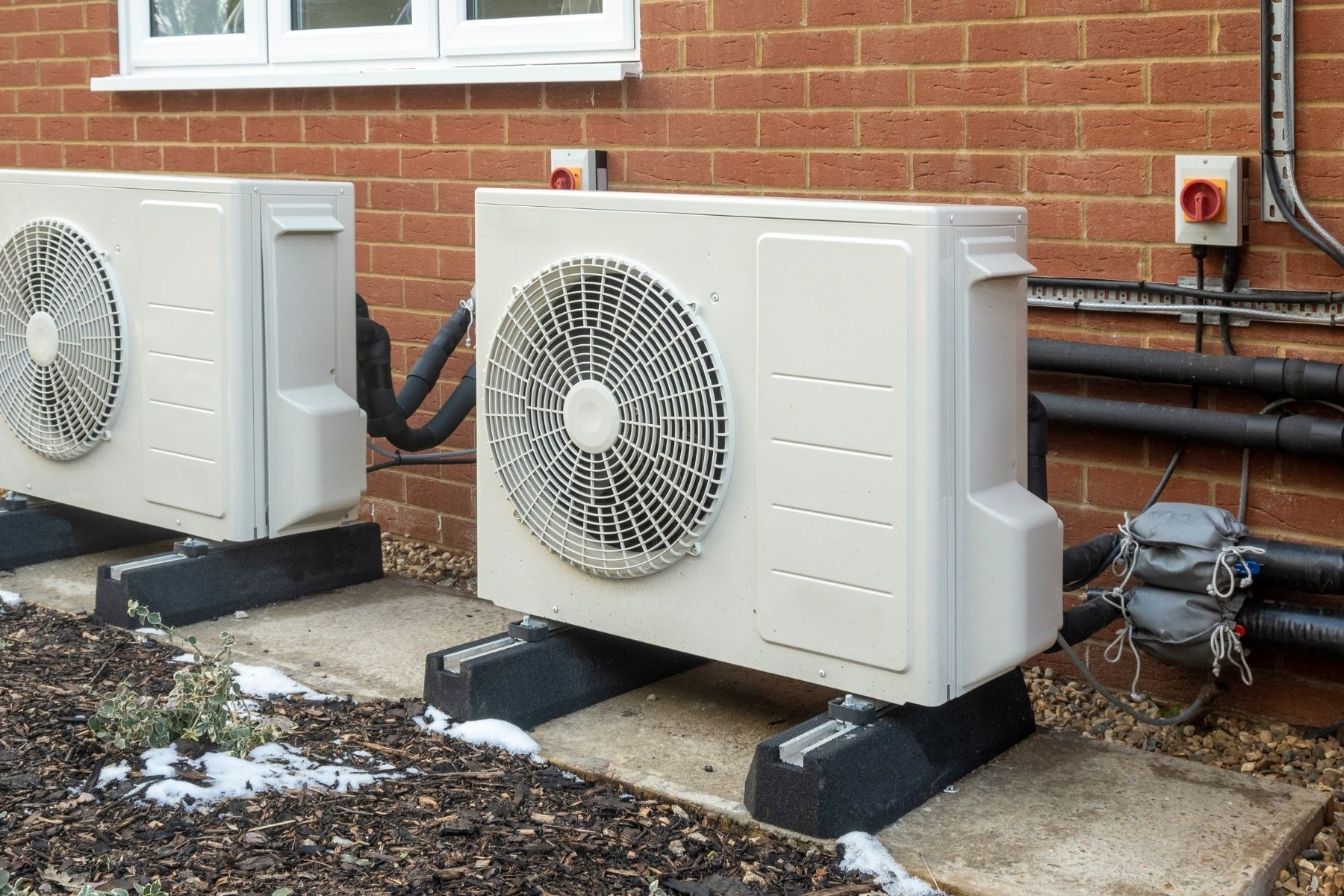 Two heat pumps installed externally to a new build home