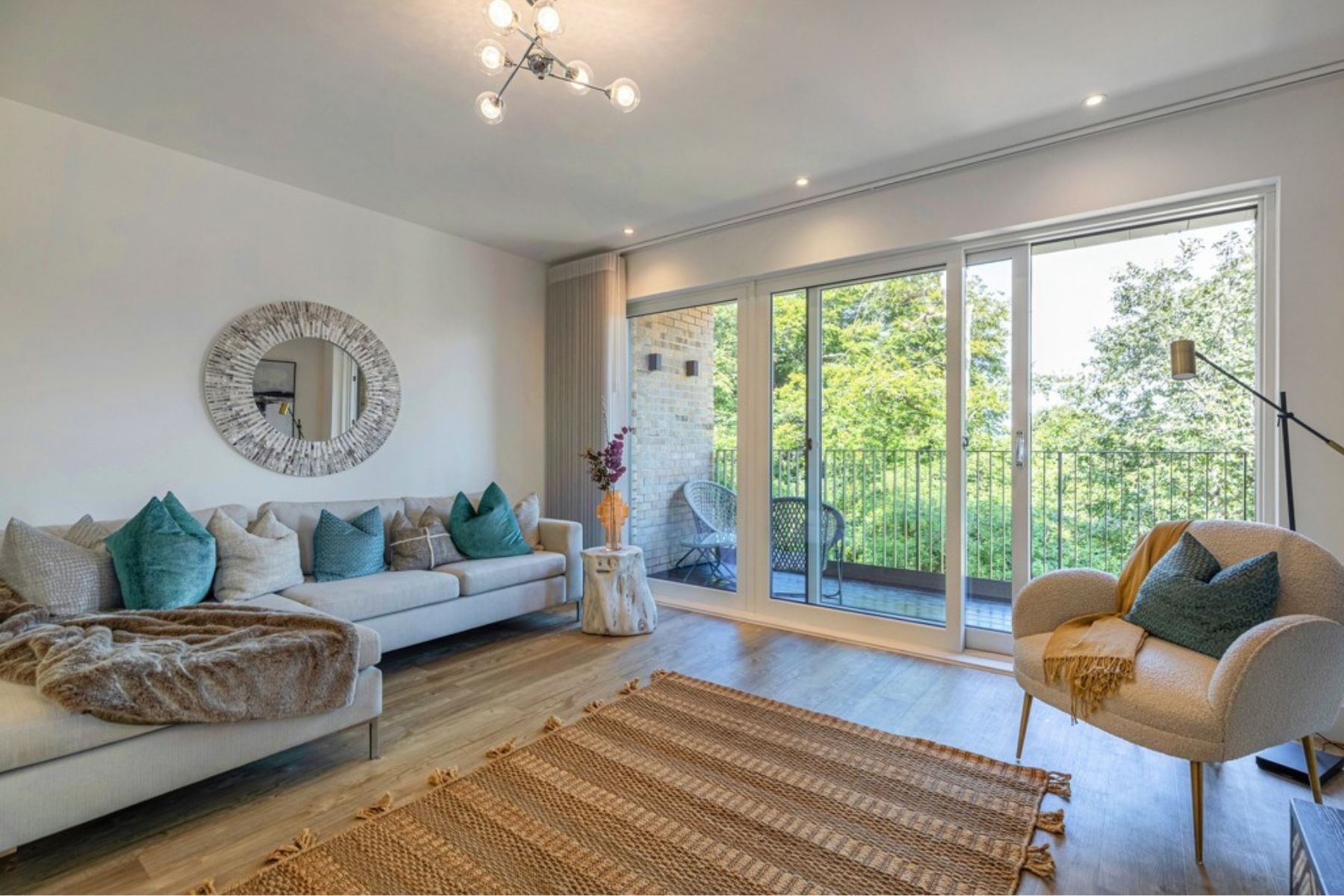 Lounge with glass doors to balcony at Jordanhill Park by Cala Homes